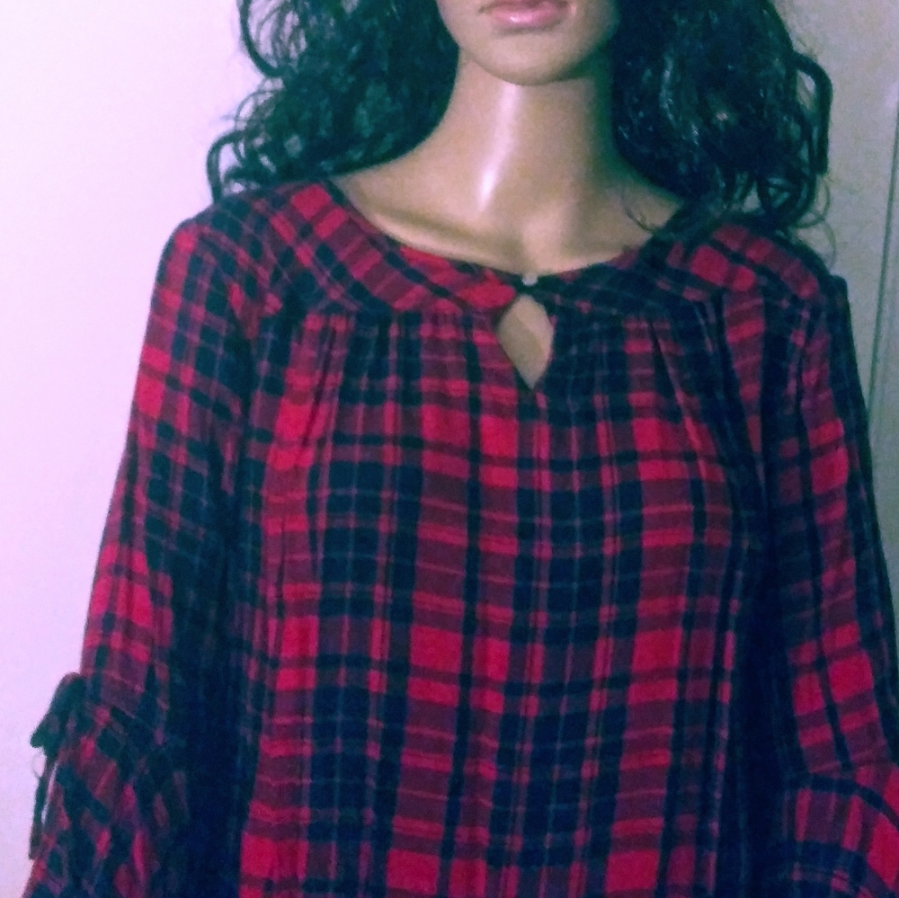 Top. Flare at end of sleeves.